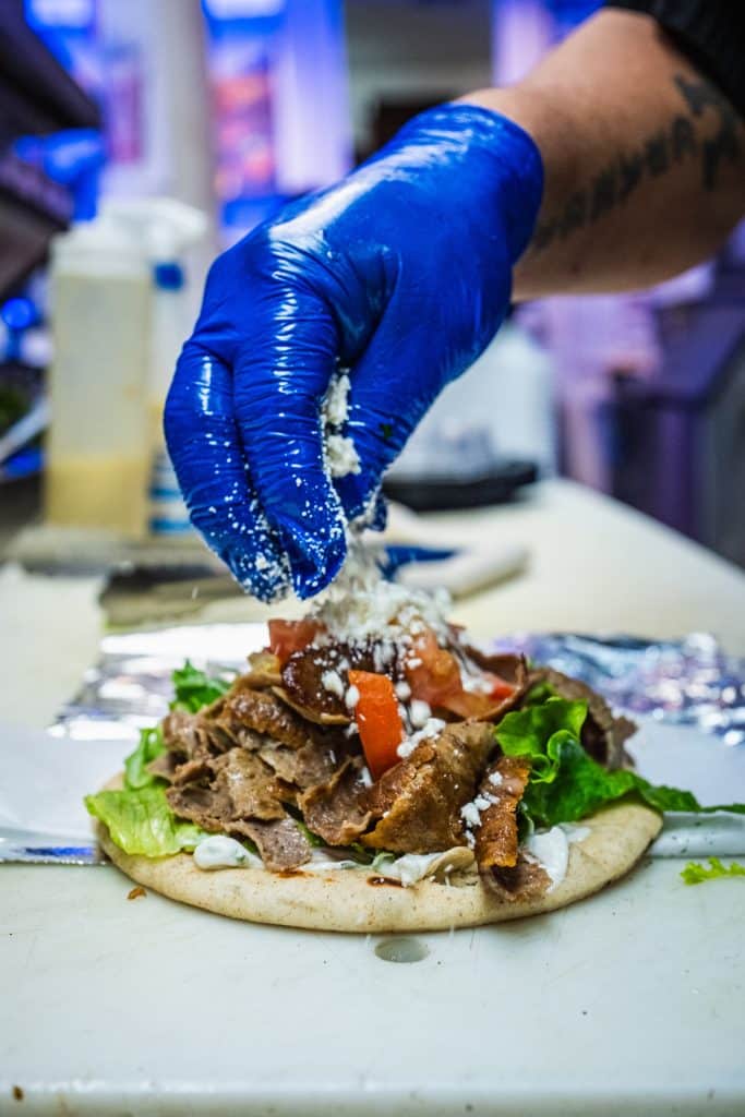 Hand assembling a delicious sandwich